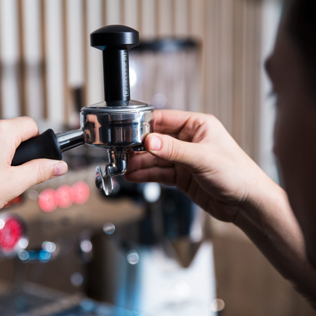 barista checking tamp level